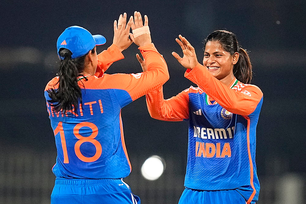 | Photo: PTI/R Senthilkumar : Radha Yadav celebrates with Smriti Mandhana after taking the wicket of South Africa Women’s captain Laura Wolvaardt